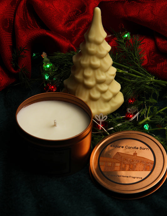 Irish Soy Wax Candle in a copper tin surrounded by Christmas Tree decorations
