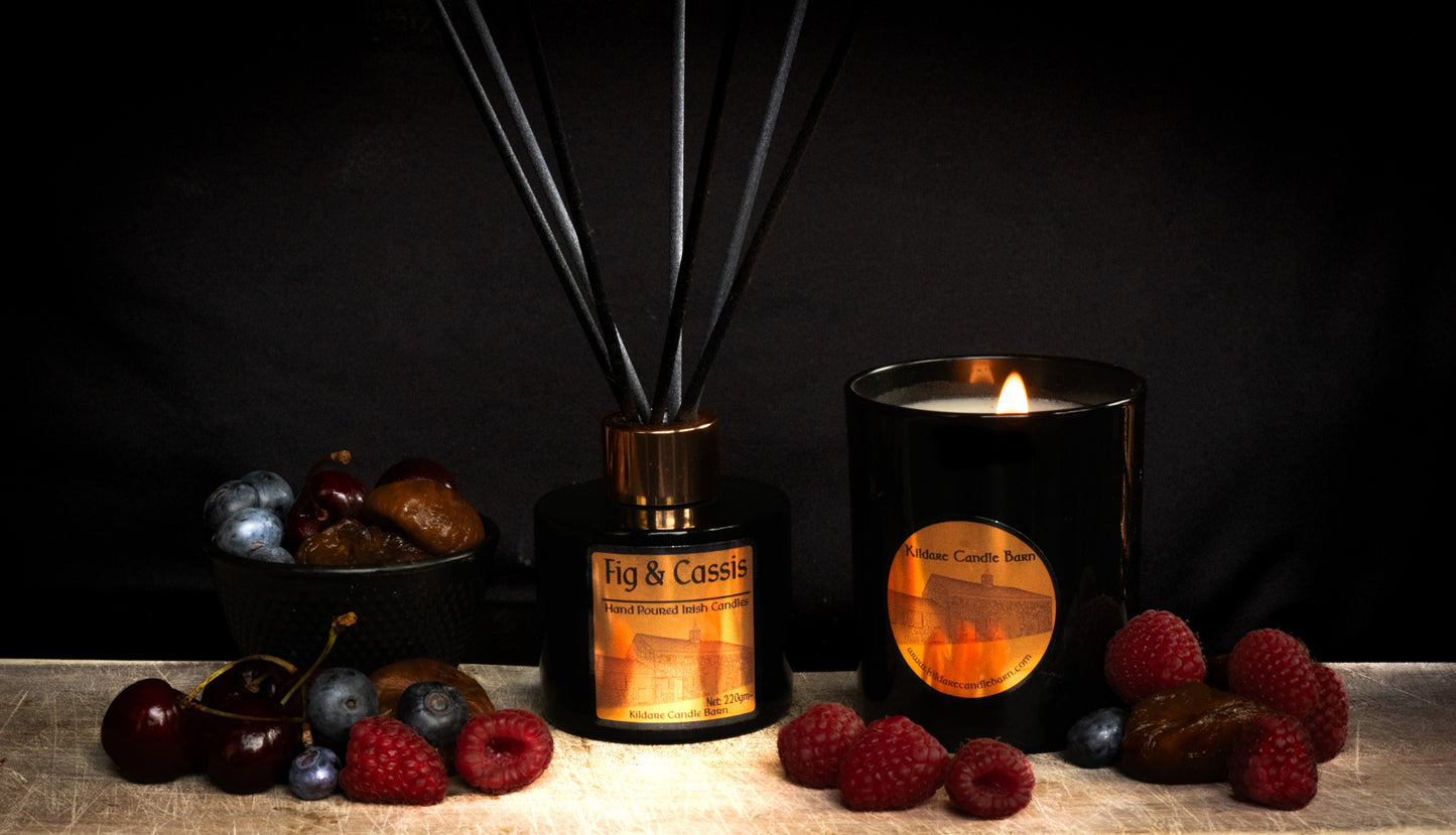 Fig & Cassis Fragrance diffuser and candle with berries on a dark background