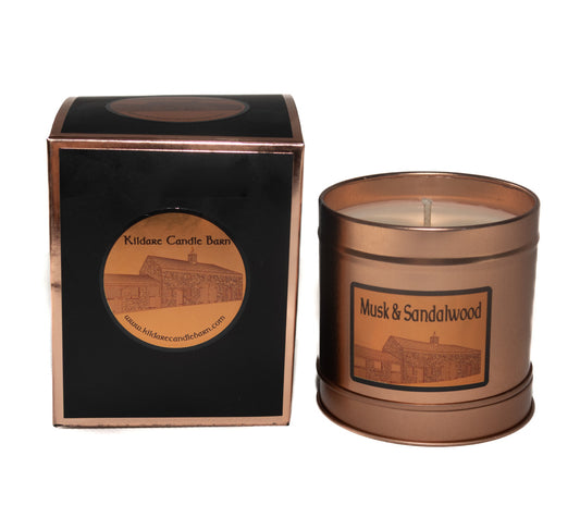 Irish Soy Wax Candle in a copper tin labelled Musk & Sandalwood with a matching gift box on a white background