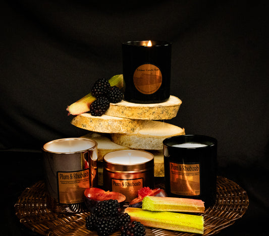 Candle display with various Irish soy wax candles and fruits of plum, rhubarb and blackberry. 3 candle vessels.