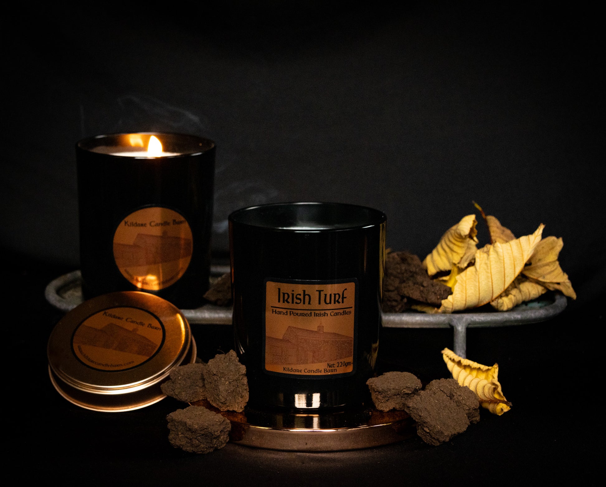 Irish Soy Wax Candles in  black  jar with 'Irish Turf' branding on a dark background and smoking turf embers.