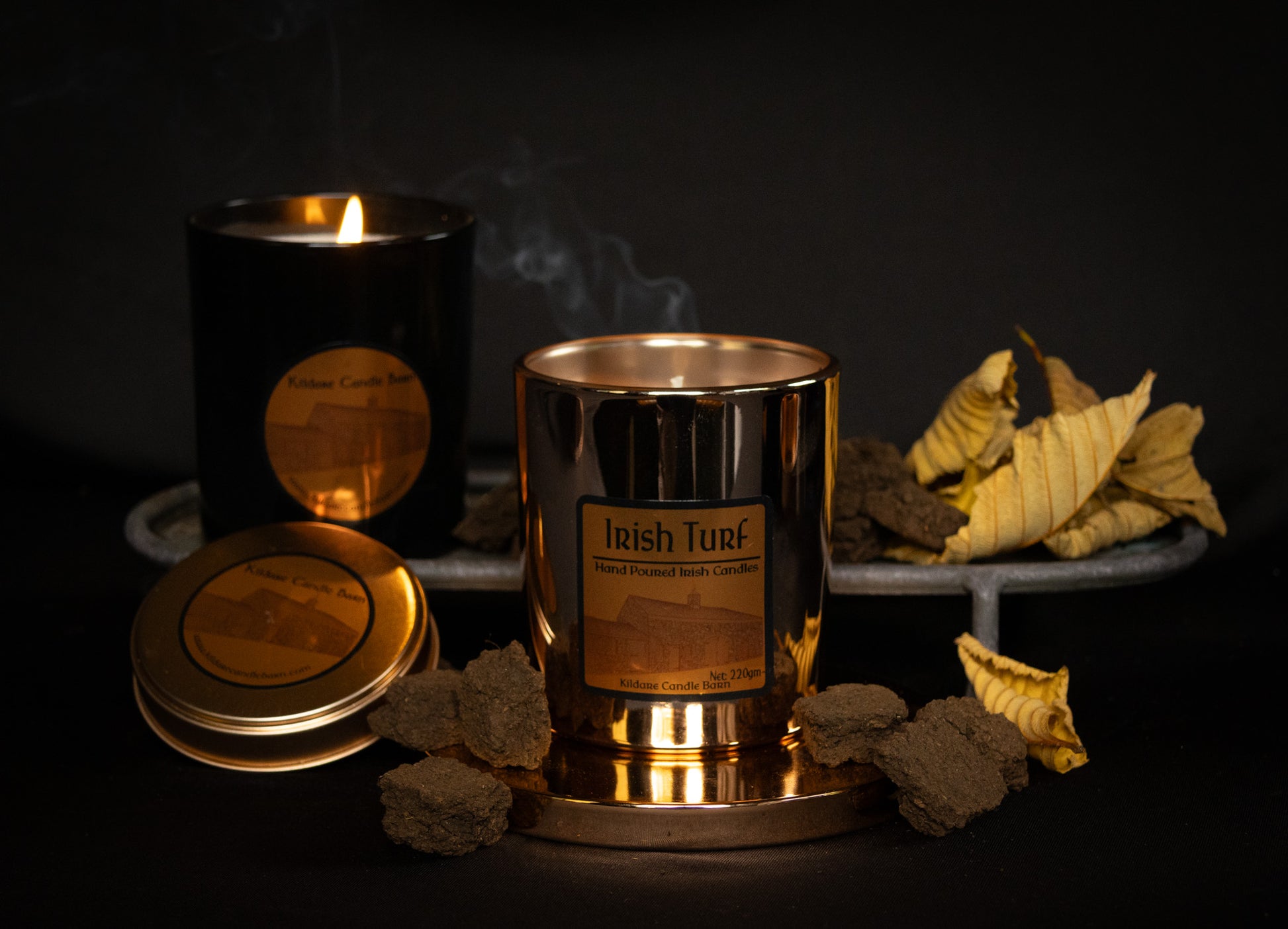 Irish Soy Wax Candles in  copper  jar with 'Irish Turf' branding on a dark background and smoking turf embers.