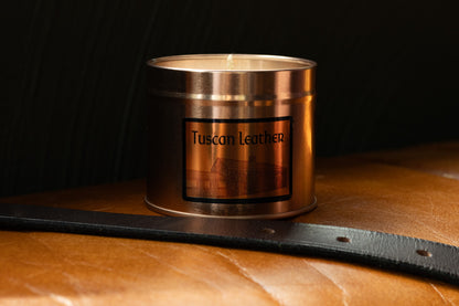 Irish Soy Wax Candle in a Copper container with 'Tuscan Leather' label on a leather surface